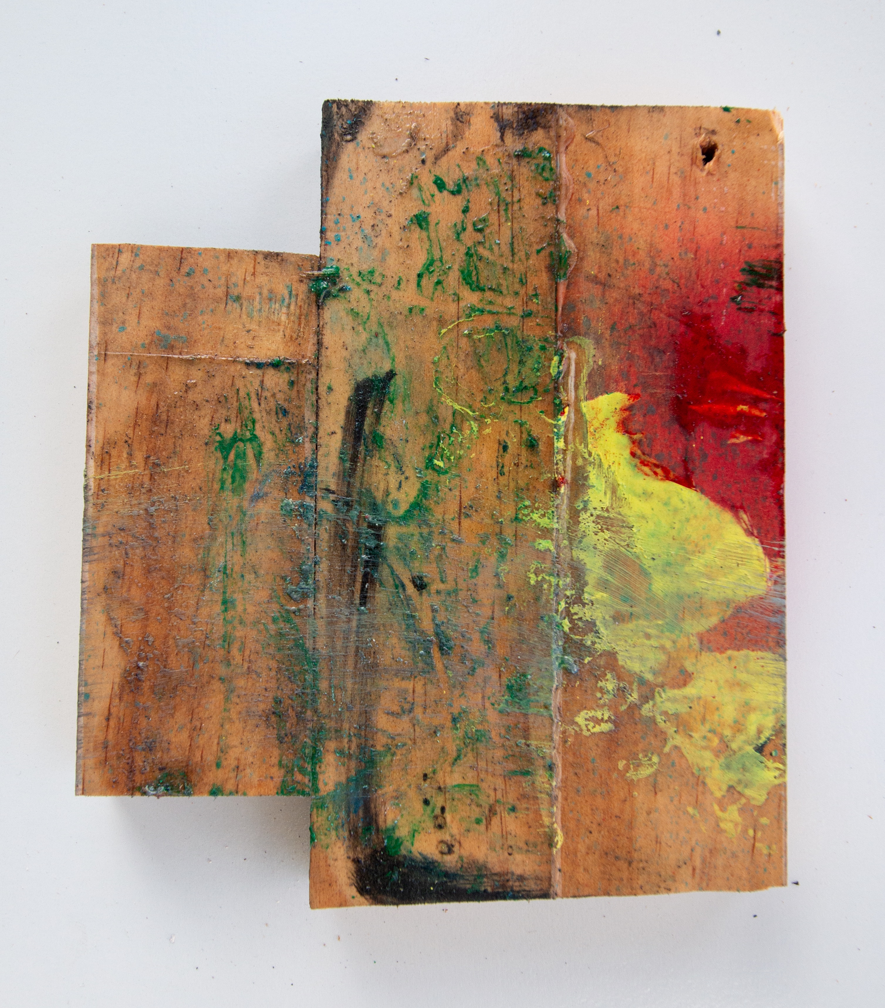 Irregular wood-block combine, a smaller plank set beside a larger one. Green and black smears wash across both; a buttery-yellow splotch and a red field saturate the right edge.